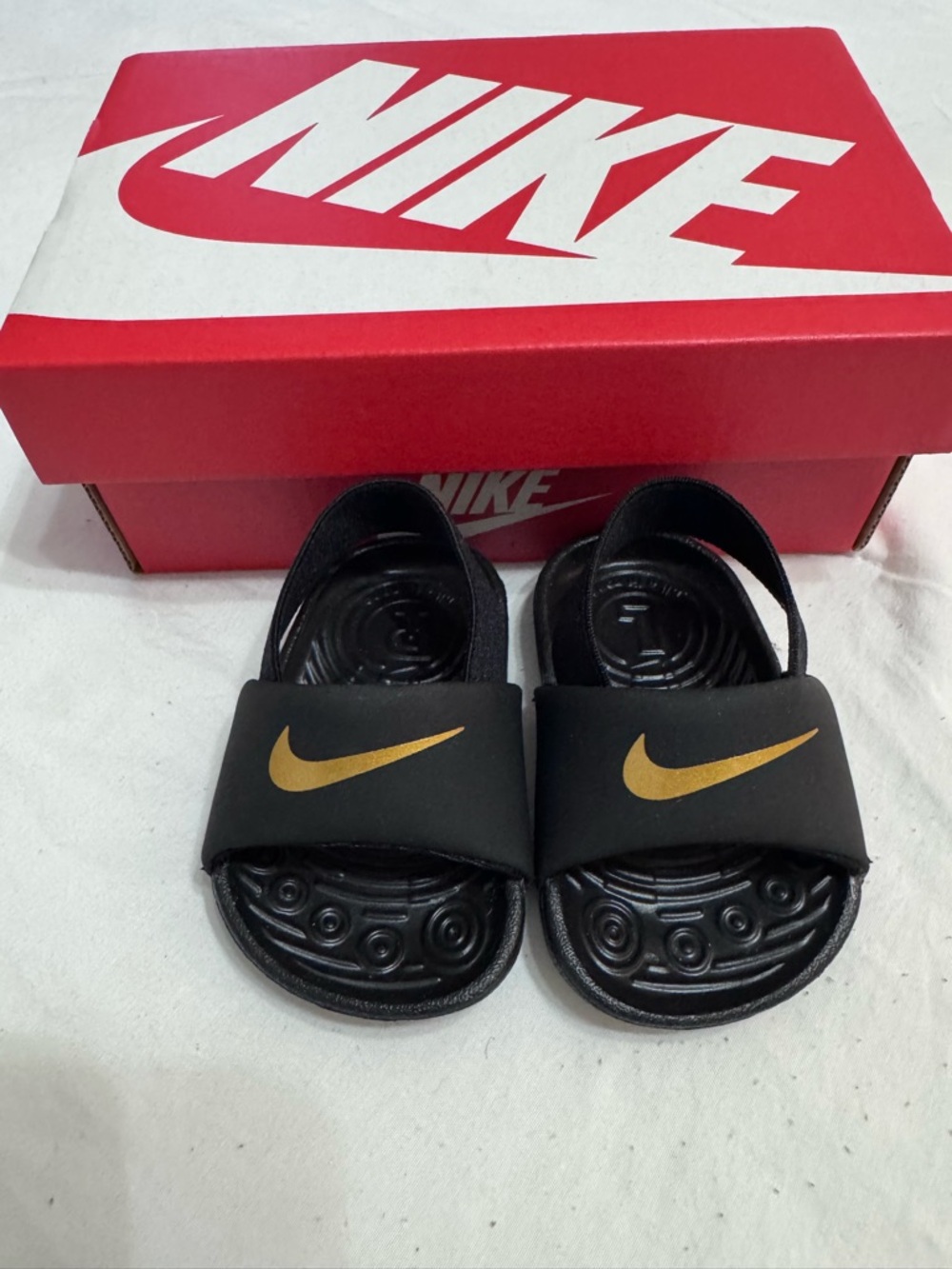 Nike Infant Black Slide Sandals with Gold Swoosh